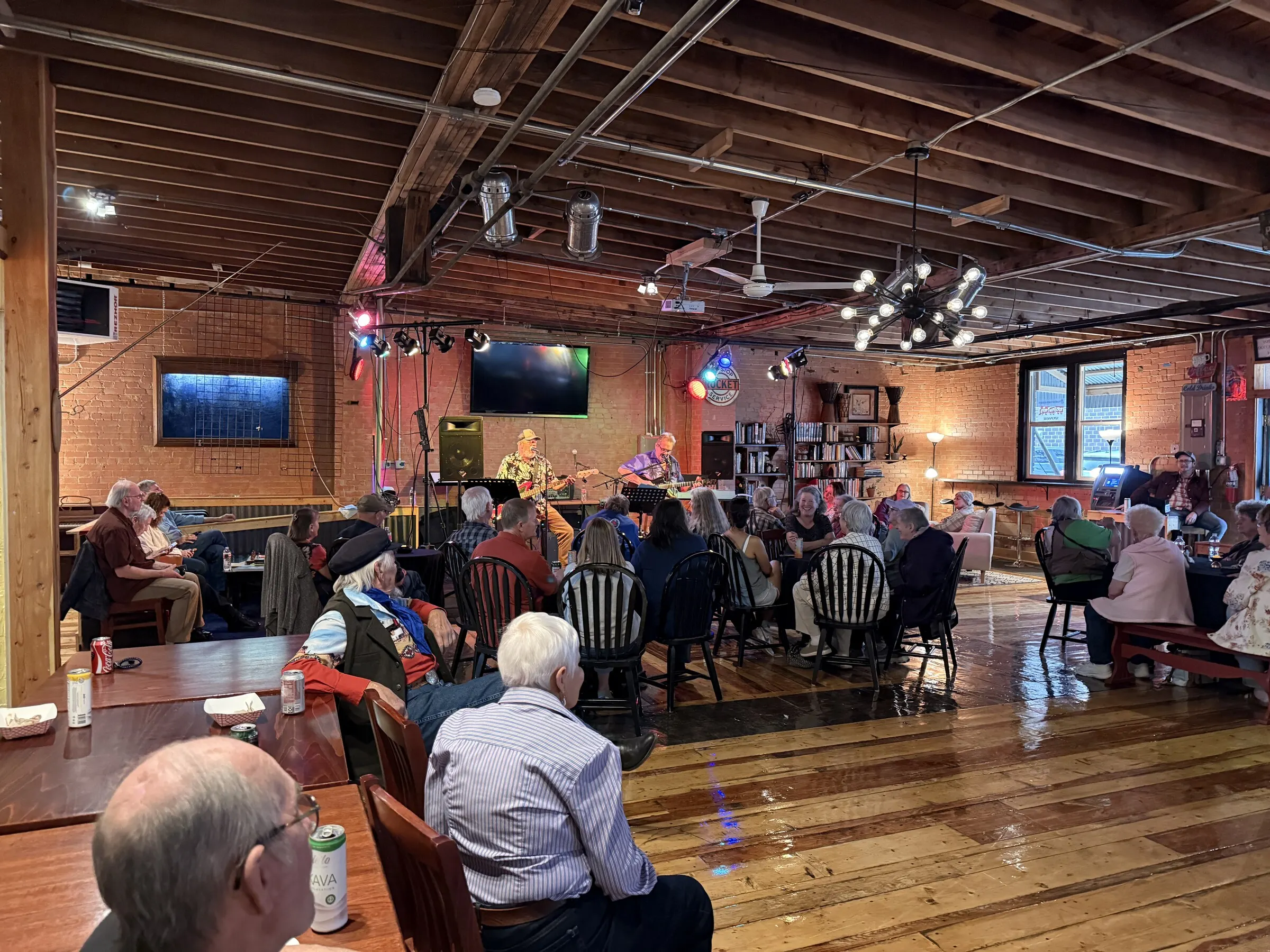 Seated audience listening to live music in The Living Room