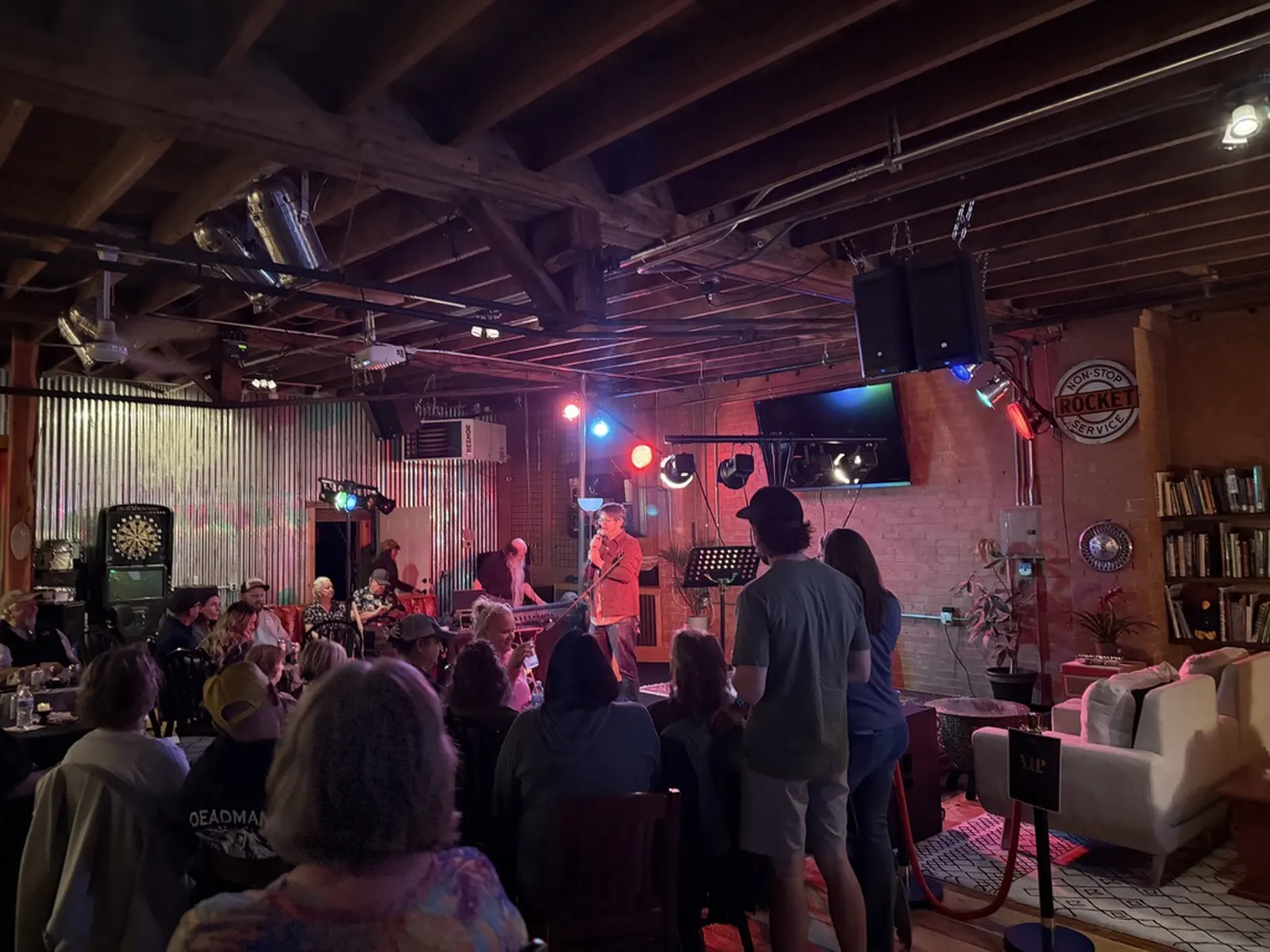 Packed room watching a performer at open mic night